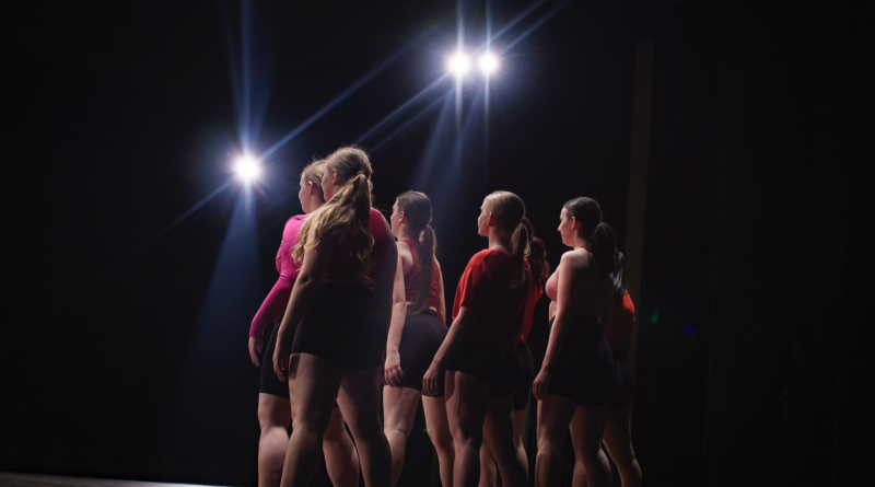 dancers on stage under the lights