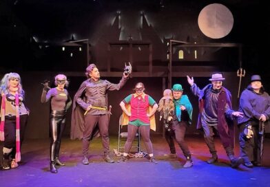 8 actors in costume on stage - Bat Man theme