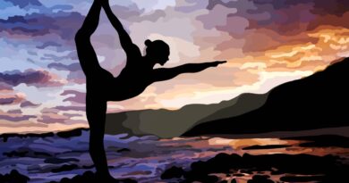 Silhouette of woman doing dancer's pose on the beach.