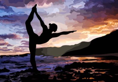 Silhouette of woman doing dancer's pose on the beach.