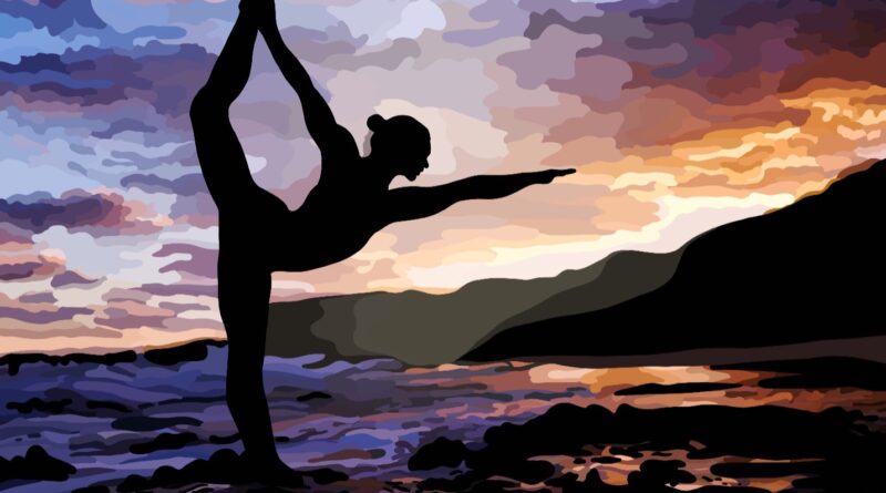Silhouette of woman doing dancer's pose on the beach.