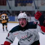 Cowichan Capital player raising stick in victory