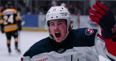 Cowichan Capital player raising stick in victory