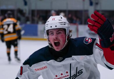 Cowichan Capital player raising stick in victory