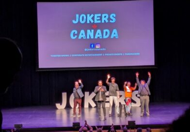 Comedians on a black stage with purple lighting