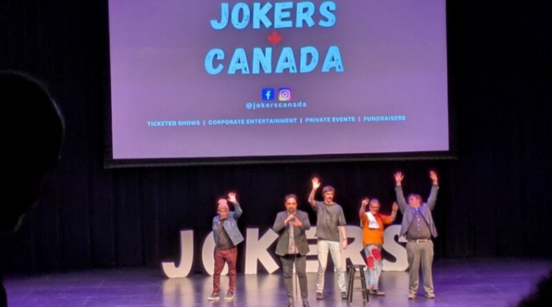 Comedians on a black stage with purple lighting