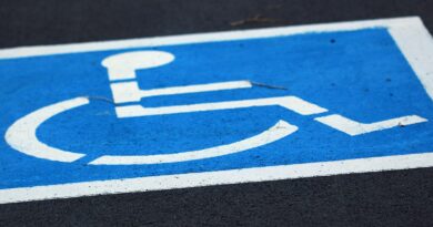 wheelchair parking symbol in blue on black background