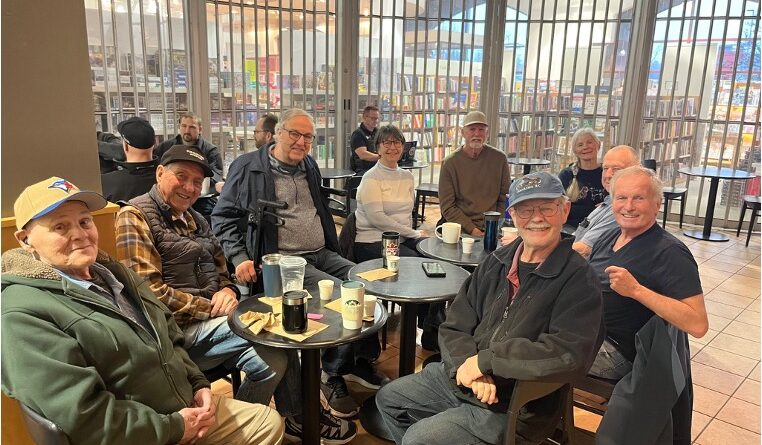 Group of seniors sitting at cafe tables