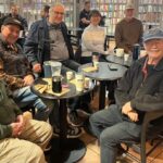 Group of seniors sitting at cafe tables