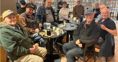 Group of seniors sitting at cafe tables