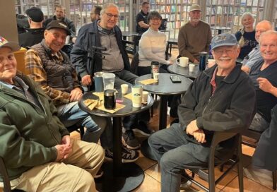 Group of seniors sitting at cafe tables
