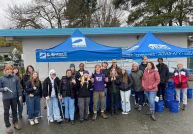 VIU Surfrider Club volunteers at a Clean-up event under a blue tent.