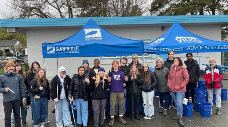 VIU Surfrider Club volunteers at a Clean-up event under a blue tent.