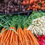 carrots, radishes, beans, beets in a pile