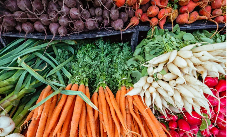 carrots, radishes, beans, beets in a pile
