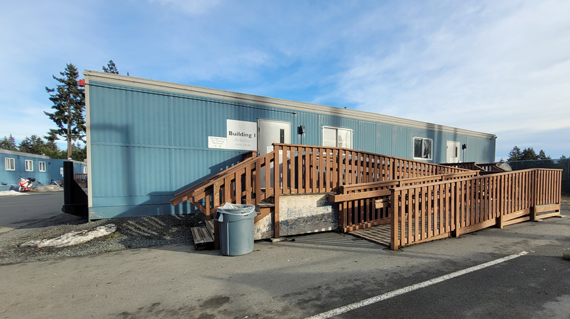 blue container housing with fence